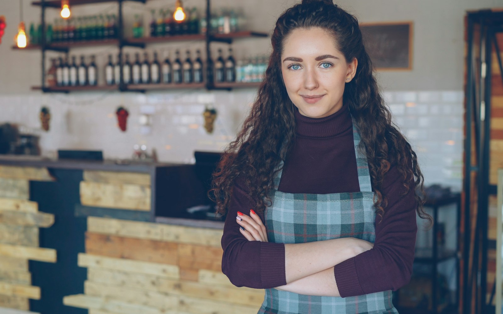 A proud small business owner standing in her shop